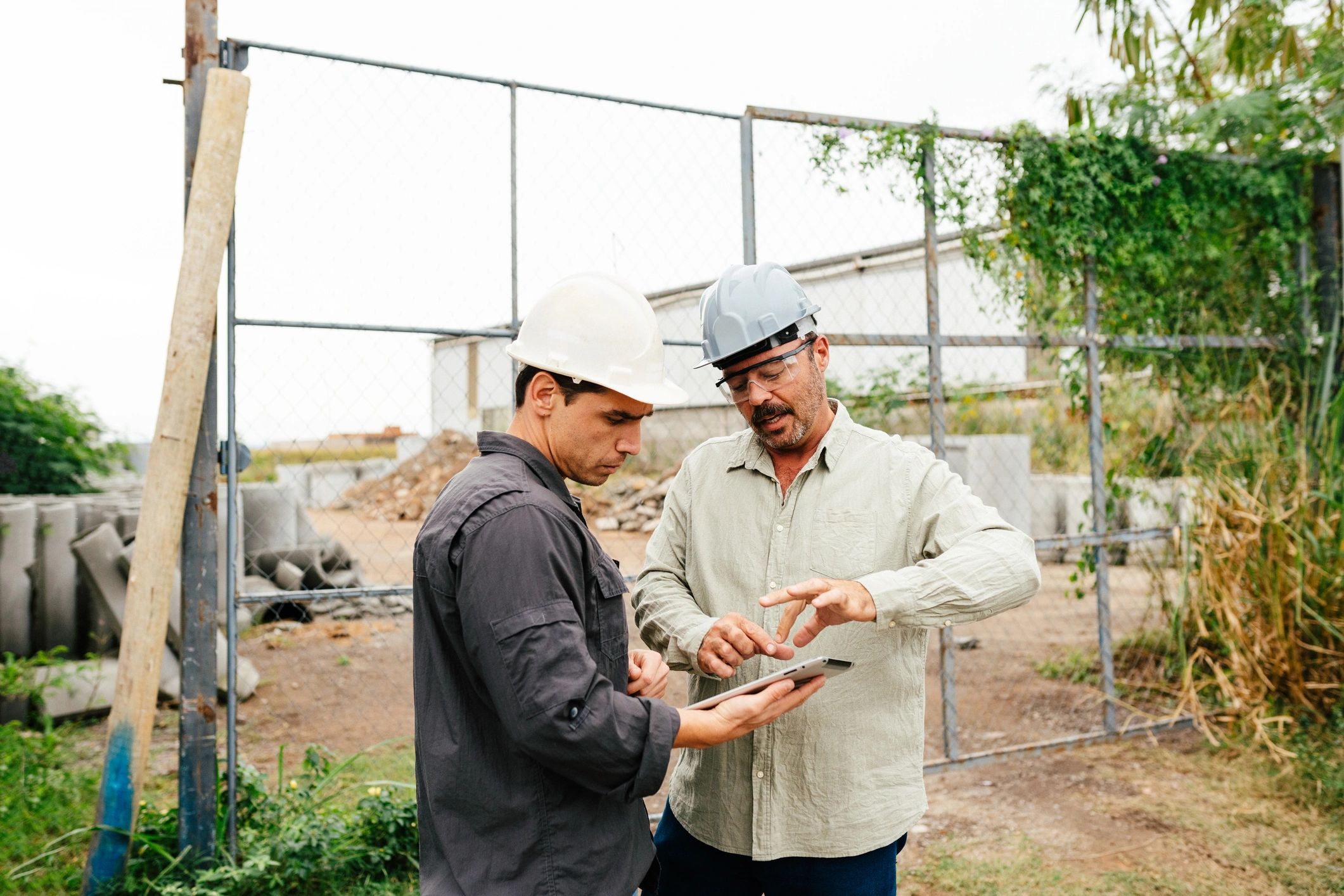 Workers reviewing workforce plans on a tablet